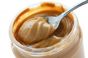 13094043-an-open-jar-of-peanut-butter-with-spoon
